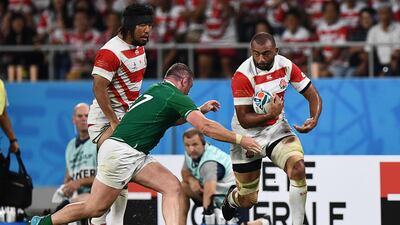 Japan's back row Michael Leitch (R) runs with the ball as Ireland's prop Dave Kilcoyne (C) goes to tackle during the Japan 2019 Rugby World Cup Pool A match between Japan and Ireland at the Shizuoka Stadium Ecopa in Shizuoka. AFP