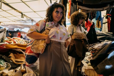 Fatma considers a pair of men's Armani trousers. "Where is the fun if you are restricting yourself and your style? I think I discovered my style through thrifting and really trying out stupid stuff sometimes." Erin Clare Brown / The National