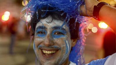 An Argentina fan celebrates after his team beat Bosnia and Herzegovina in a Group F soccer match of the 2014 World Cup, along Copacabana Beach in Rio de Janeiro, June 15, 2014. REUTERS/Marco Bello