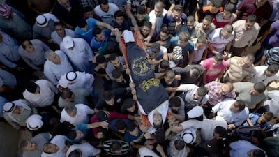 Palestinian mourners carry the body of Diyaa Talahmeh, 21, during his funeral in the West Bank village of Khursa, near Hebron. Majdi Mohammed / AP Photo