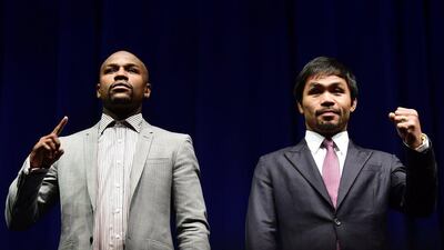 Boxers Manny Pacquiao, right, from the Philippines and Floyd Mayweather from the US gesture while posing during their Wednesday press conference in LA to promote their much-anticipated May 2 bout. Frederic J Brown / AFP