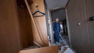 An Iranian man attends his damaged office in Tehran. AFP