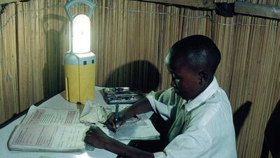 A young boy studies by the light of a low-cost, solar-powered lamp provided by an Energy Prize competitor, Practical Action. Courtesy Practical Action