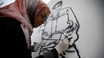 Haifa Subay says her paintings depict the suffering of women and children in Yemen's three-year civil war. Mohamed Al Sayaghi / Reuters
