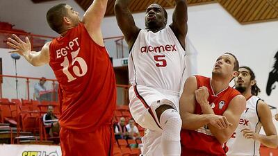 Omar Samhan, 15, of Egypt, goes for a block against Jordanian side Al Riyadi Aramex of Amman. Satish Kumar / The National