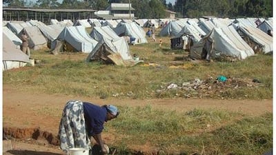 A woman washes a pot at the Eldoret camp in western Kenya, which still houses 2,500 people left homeless in last year's post-poll violence. Matt Brown / The National