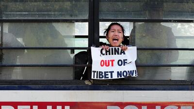 A Tibetan exile shouts anti-China slogans after being detained by Indian police during a protest outside the Chinese embassy in New Delhi. Money Sharma / AFP