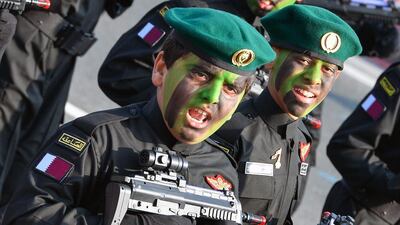 Qatari children dressed in Emiri Guard costumes.