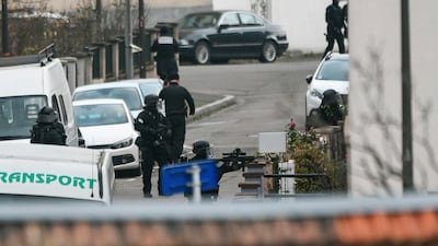 French police special forces take part in an operation in Neudorf, Strasbourg, where the gunman was dropped off by a taxi he commandeered (AFP)