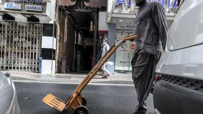 Dubai Police are looking to replace dolly carts used by porters in the Naif neighbourhood with licensed vehicles to prevent theft and accidents. All photos by Antonie Robertson / The National