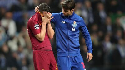 Porto midfielder Oliver Torres, right, comforts Roma midfielder Alessandro Florenzi at the end of their Uefa Champions League last-16 second-leg match. Luis Vieira / AP Photo