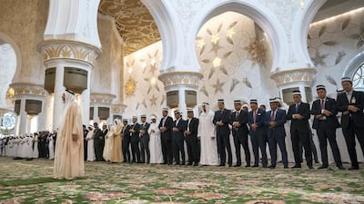 Sheikh Mohamed bin Zayed Al Nahyan, Crown Prince of Abu Dhabi and Deputy Supreme Commander of the UAE Armed Forces, and King Sultan Abdullah Sultan Ahmad Shah of Malaysia (9th R), attend Friday prayers at Sheikh Zayed Grand Mosque. Seen with members of the Malaysian delegation. Photos by Hamad Al Kaabi / Ministry of Presidential Affairs