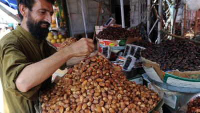 A Pakistani vendor arranges dates at his stall in Islamabad. AFP
