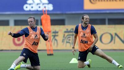 Wayne Rooney of Manchester United, left, warms up during the team training session as part of their pre-season tour of China at Shanghai Stadium on July 21, 2016 in Shanghai, China. Lintao Zhang / Getty Images