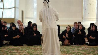 Ahmed al Mehairbi, one of the few Emiratis working in the service sector, conducts a guided tour at the Sheikh Zayed Mosque.
