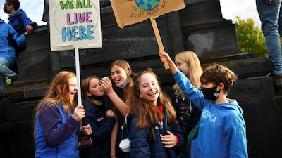 Young people holding placards attend the Fridays for Future march. Reuters