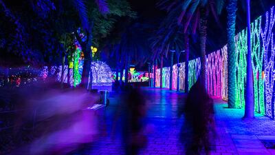 Visitors walk through the brightly-lit attraction