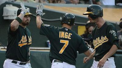 Brandon Inge is congratulated by Derek Norris as Oakland defeat the Yankees
