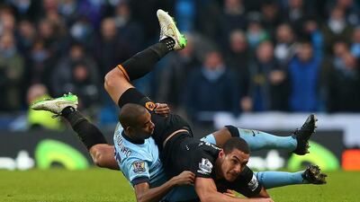 Jake Livermore, in black, of Hull City tangles with Fernandinho of Manchester City during their Premier League match at the Etihad Stadium on February 7, 2015, in Manchester, England. Alex Livesey / Getty Images