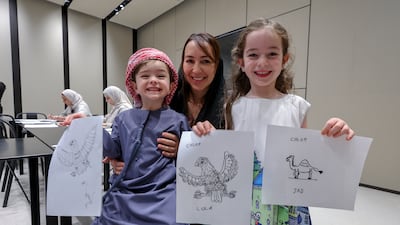 Fatima Hezam and her children, Chloe, six, and Noah, three, take part in World Autism Awareness Day activities at Zayed National Museum. Victor Besa / The National