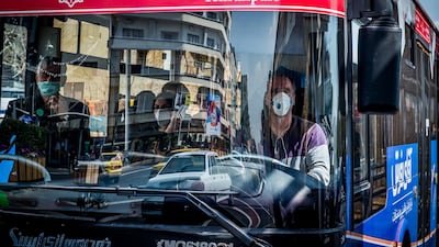 A public bus driver wears a protective face mask while working in central Tehran, March 15. Bloomberg
