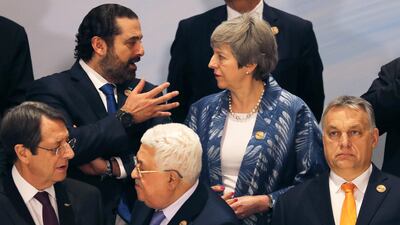 Britain's Prime Minister Theresa May and Lebanese Prime Minister Saad Al Hariri in discussion during the family photo. Reuters