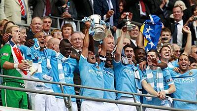 Manchester City's players pose with the trophy.
