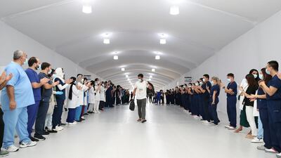 Medical staff at Dubai Parks and Resort field hospital cheer as their final 17 coronavirus patients are discharged. Chris Whiteoak / The National