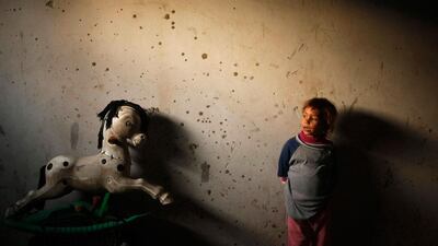 A Palestinian girl looks on inside her family's damaged house in Beit Lahiya, near the border between Israel and northern Gaza Strip. Mohammed Salem