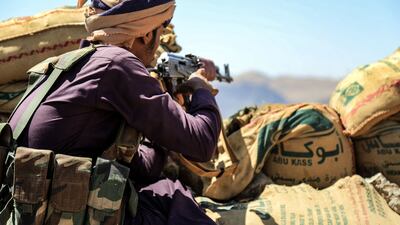 A fighter loyal to Yemen's Saudi Arabia-backed government guards a position near the frontline facing Houthi rebels in the country's north-east province of Marib, on October 17, 2021. AFP