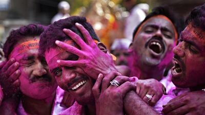 Hindu devotees smeared in colored powder during a procession for the immersion of idols of elephant-headed Hindu god Ganesha on Thursday, September 15 2016. Elephants are considered sacred in Sri anka and parts of India. Channi Anand / AP