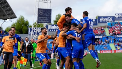 Getafe's Mason Greenwood, centre right, joins in the celebrations after teammate Nemanja Maksimovic scored his side's third goal in a 3-2 win against Osasuna. AP