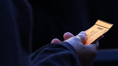 A person holds their ticket for a turkey during a Thanksgiving food distribution event at Food Bank For New York City in Harlem. AFP
