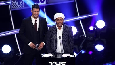 Former German footballer, Michael Ballack (L) and former Brazillian footballer Ronaldinho, present the FIFA FIFPro World11 Award. Getty Images