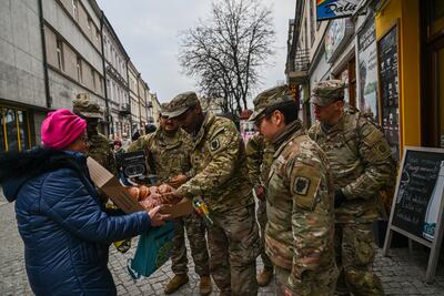 US Army soldiers are offered donuts in Przemysl, Poland. Getty