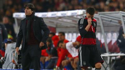 Mesut Ozil comes off, walking by Germany coach Joachim Loew, during the 1-0 win over Chile on Wednesday March 5, 2014. Michael Dalder / Reuters