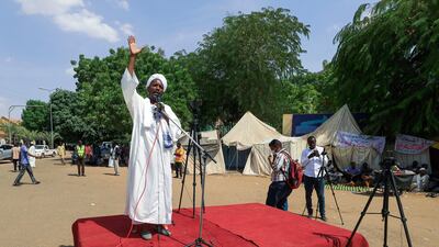 An imam gives the sermon following Friday prayers performed by pro-military protesters in front of the Republican Palace. AFP