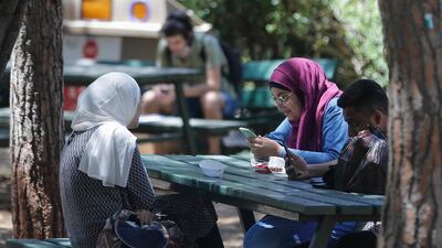 Students sit together under the shade of trees at the American University of Beirut. AFP