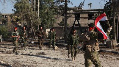 Syrian pro-government soldiers patrol the area of Awijah as they advance in Aleppo's rebel-held neighbourhoods on October 8, 2016. George Ourfalian/ AFP