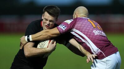 Dubai Exiles' Tom Stapley pushes past the tackle of Doha's Gregory Evans during their West Asia Championship match at The Sevens in Dubai on January 29, 2016. Christopher Pike / The National Job ID: 42513 Reporter: Paul Radley Section: Sport Keywords: