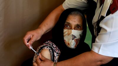 Kaironesa Suleman Allie, 76, receives a first dose of the Pfizer Covid-19 vaccine at a vaccination centre in Karl Bremer Hospital, in Cape Town, South Africa. South Africa is in a race against time to vaccinate as many people as possible with signs the virus may be surging again. AP Photo
