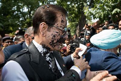 Black ink is thrown at India's Sahara group chairman Subrata Roy's face as he arrives at the Supreme Court in New Delhi. Prakash Singh / AFP Photo