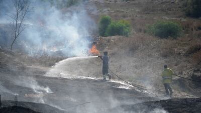 Israeli crews extinguish fires started by incendiary balloons launched from the Gaza Strip. Palestinians in recent days staged protests near the border fence between Israel and Gaza. AP Photo