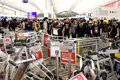 Pro-democracy protestors block the entrance to the airport terminals after a scuffle with police at Hong Kong's international airport late. AFP