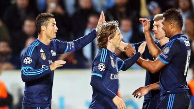Real Madrid's Cristiano Ronaldo celebrates with teammates after scoring the second goal, levelling Raul's record mark for Real, in their Champions League win over Malmo. Andreas Hillergren / EPA