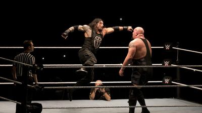 Roman Reigns, left, will be the star of Sunday's WWE Royal Rumble, but he will not leave with the WWE World Heavyweight title. Manish Swarup / AP Photo