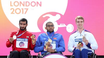 Tunisia's Walid Ktila, centre, with UAE's Mohammed Al Jammadi, left, and Great Britain's Isaac Towers with his bronze medal, right, after the men's 800m T34 final. Simon Cooper / Press Association