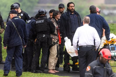 An emergency response team untethers protester Guido Reichstadter. EPA