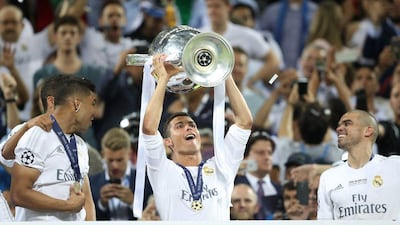 Cristiano Ronaldo holds aloft the Uefa Champions League trophy after Real Madrid beat Atletico Madrid 5-3 on penalties. Carl Recine / Action Images