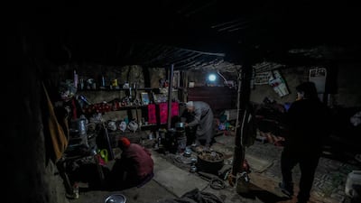 Village head Gyaltsan Zangpo and his wife prepare dough for bread.
